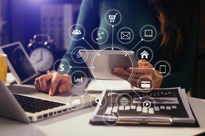 Businesswoman working with smart phone and laptop and digital tablet computer in office with digital marketing media in virtual icon.